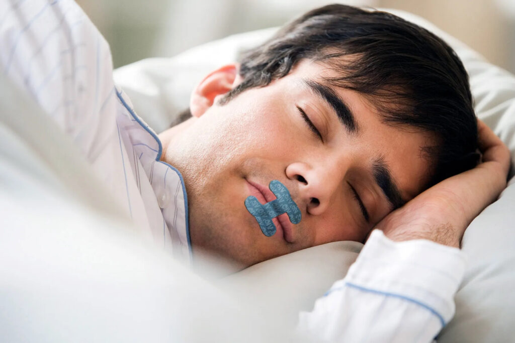 person sleeping with lip tape