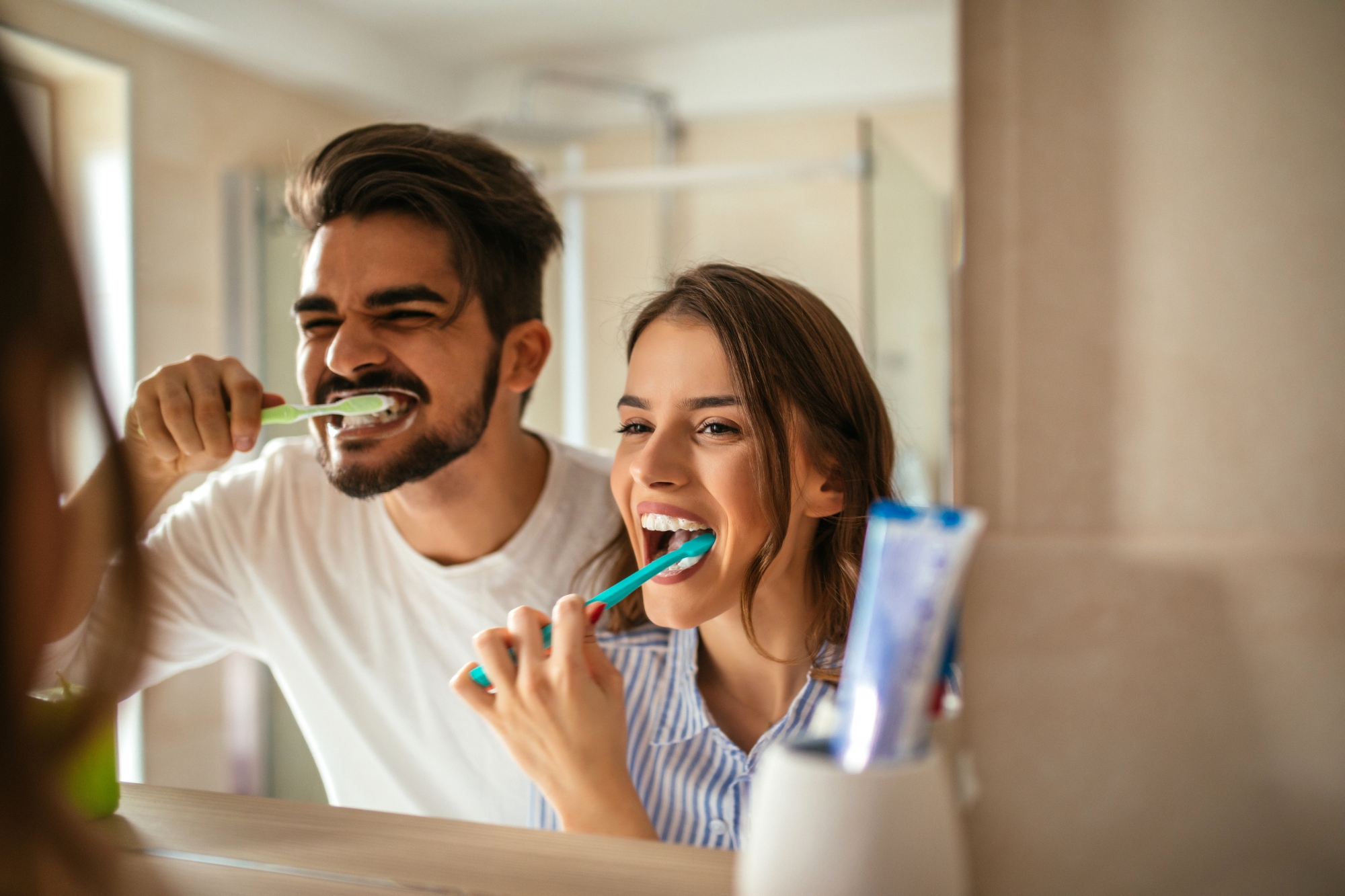 Couple brushing teeth together