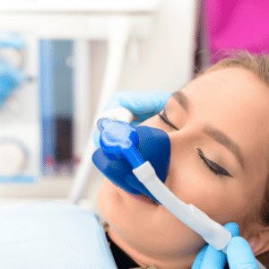 A woman receives sedation at the dentist.