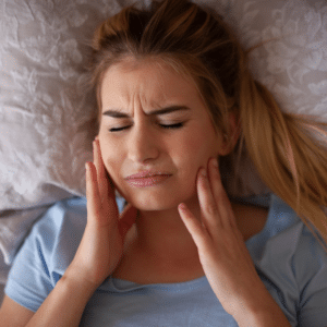 A woman is laying in bed for her surgery recovery.