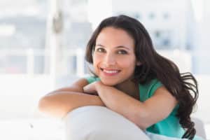 Pretty brunette relaxing on the couch at home