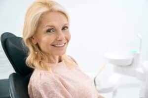 Smiling patient after receiving a dental bridge