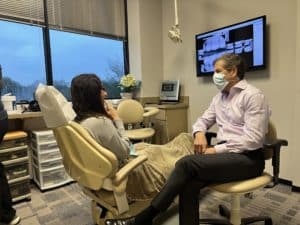 Patient discussing ear pain related to TMJ with a specialist
